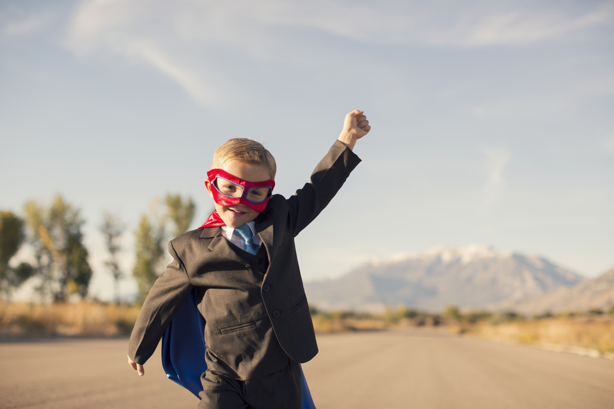 Young Boy in Superhero Costume and Business Suit is Running